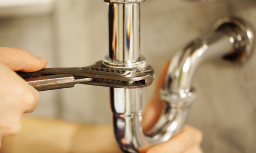 Plumber using tools to detect and fix water leaks with precision.